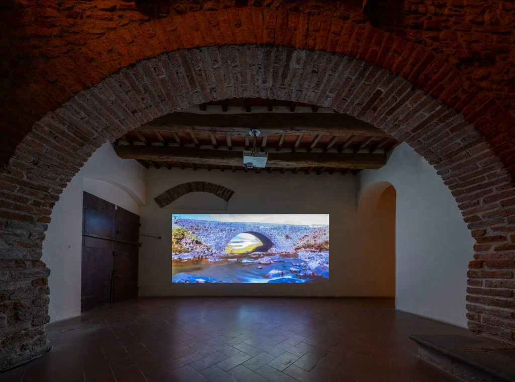 Projected film images beneath the brick arches of Casa Masaccio.