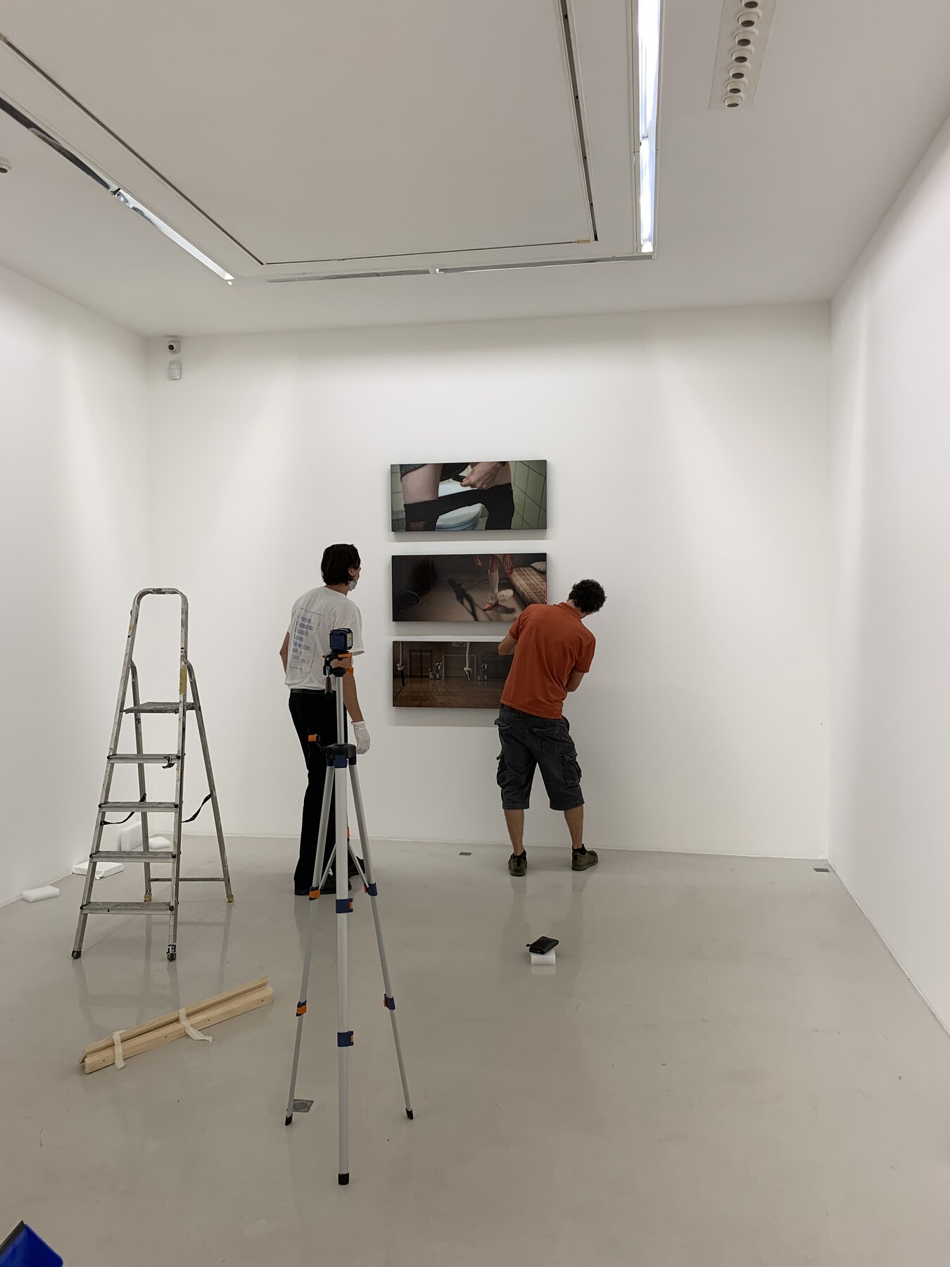 Three ARTvonTRIER works being mounted vertically