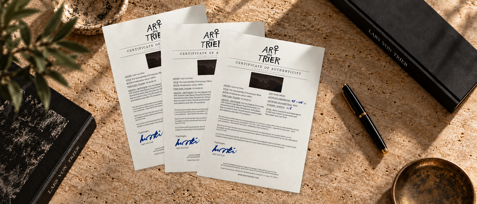 Three example Certificates of Authenticity on a travertine table